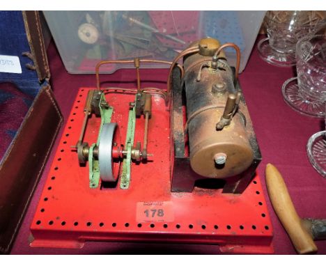 A Mamod twin cylinder live steam stationary engine. Lacks burner and funnel