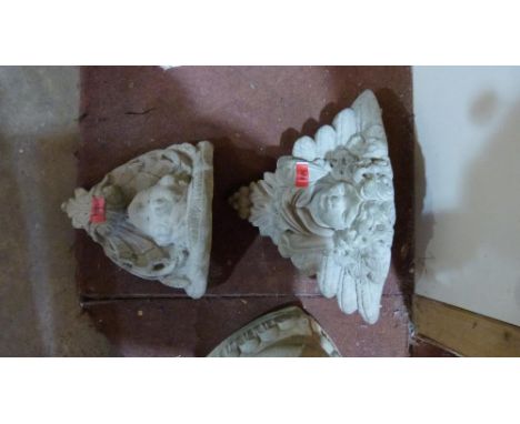A cherubic garden wall planter and a cherubic plaque