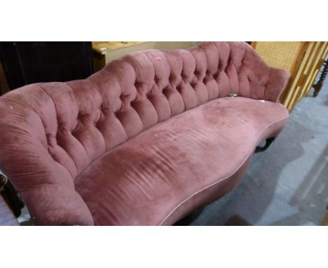 A Victorian sofa with deeply buttoned back and serpentine seat on turned legs and brass castors. 72'' wide. c.1870 