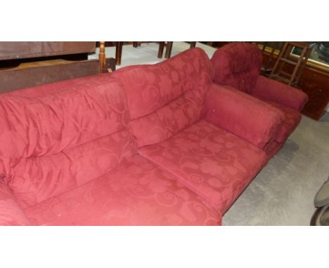 A sofa and armchair upholstered in red fabric