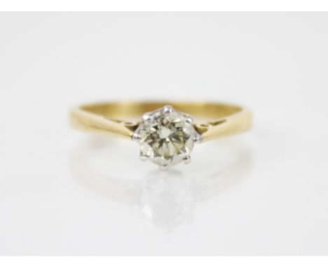 A diamond solitaire ring, the central round brilliant cut diamond weighing approximately 0.65 carats, claw set in white metal