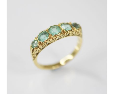 A Victorian style five stone ring, comprising five graduated round mixed cut blue-green gemstones (possibly aquamarines), lar