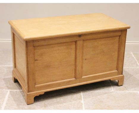 A Victorian pine blanket chest, the rectangular hinged top above a panelled front and sides, raised upon bracket feet, 69cm H