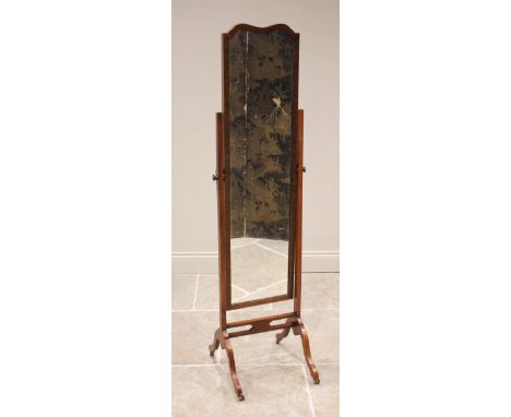 An early 20th century mahogany cheval mirror, the rectangular and shaped mirror raised upon tapering supports extending to do