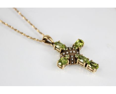 A peridot and seed pearl 9ct Celtic cross pendant, comprising five oval mixed cut peridots to a seed pearl set central sectio