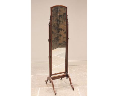 An early 20th century mahogany cheval mirror, the rectangular mirror with an inverted top, applied with carved foliate detail