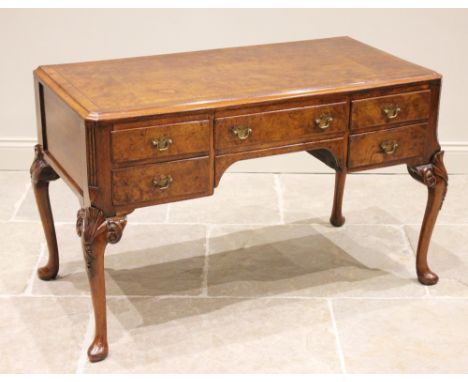 A George II style figured walnut desk, by Edwards & Roberts, late 19th Century, the rectangular book veneered top with a moul