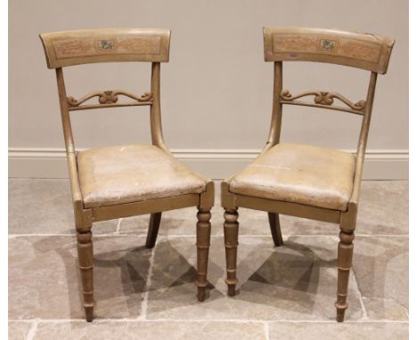 A pair of painted Regency side chairs, each with a concave top rail centred with a painted griffin, above an upholstered drop