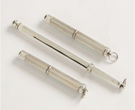 An Art Deco silver swizzle stick, of faceted form with engine turned detail, stamped 'STERLING SILVER', 8.5cm long, together 