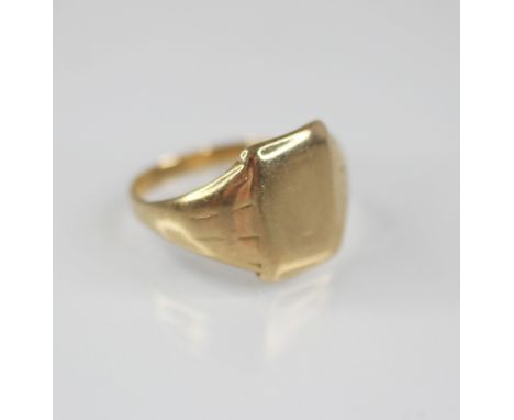 A gentleman's gold coloured signet ring, the plain polished rectangular cartouche measuring 14mm x 10mm, continuing to taperi