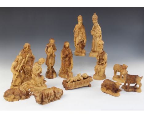 A carved olive wood Nativity scene, comprising Baby Jesus, Mary, Joseph, three shepherds, three kings, two oxen and three she