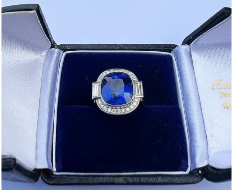 An Art Deco Revival sapphire and diamond ring, the central cushion cut blue sapphire measuring approximately 9.5 carats, (10.