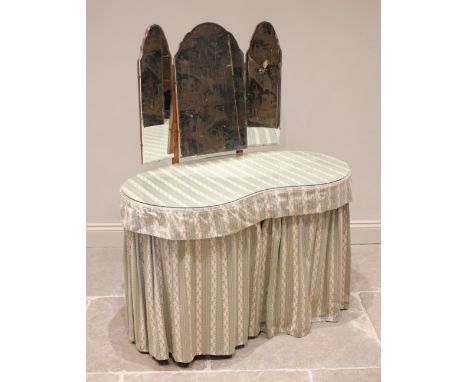 A mid 20th century kidney shaped dressing table, the triptych mirror above a pair of three drawer pedestals united by a singl