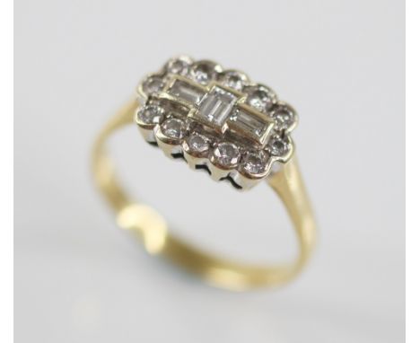A diamond 18ct gold cluster ring, the central boat shaped cluster designed as three baguette cut diamonds, with a surround of