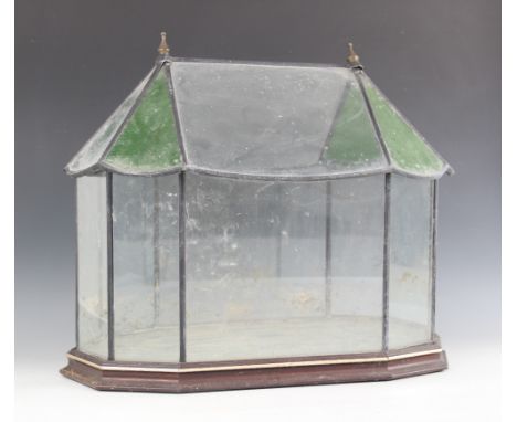 A Victorian style stained and clear glass terrarium, of architectural form, with removable cover, raised upon a hardwood plin