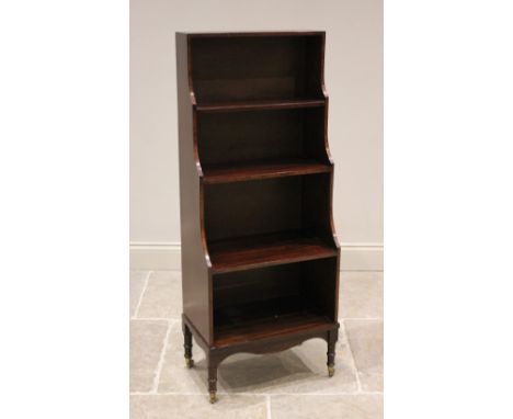A Regency style mahogany waterfall bookcase, 20th century, of diminutive proportions, the three graduated shelves above a sha