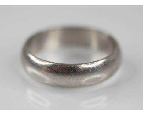 A platinum wedding band, marks for 'BMS', Birmingham 2000, ring size T 1/2, weight 10.4gms 