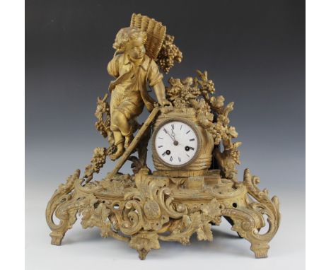 A late 19th century French gilt metal figural mantel clock, the 8cm white enamelled dial and two train movement striking on a