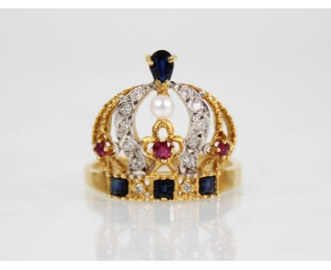 An 18ct gold diamond, ruby, sapphire and pearl ring, modelled as a crown, the band set with step cut sapphires, the arches se