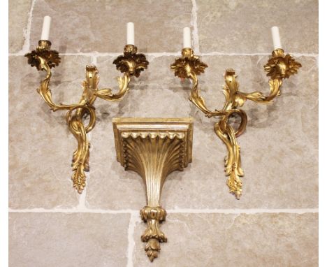 A pair of French ormolu rococo style twin branch wall light fittings, each cast with scrolling intertwined foliate branches, 