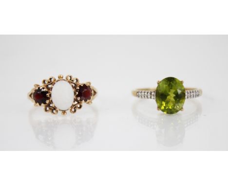 A peridot 9ct gold cocktail ring, the central oval mixed cut peridot measuring 10mm x 8mm, claw set to white stone set should