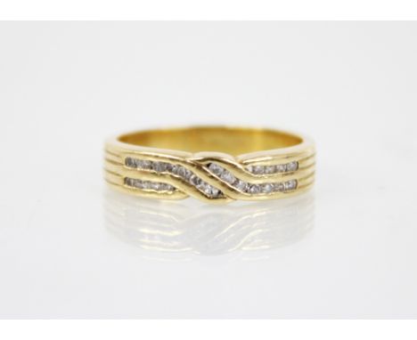 An 18ct gold diamond crossover ring, the designed as two rows of single cut diamonds, channel set in 18ct gold to banded shou