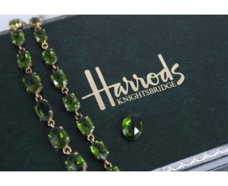 A 19th century and later paste riviere necklace, designed as a single row of graduated oval green pastes, measuring between 4