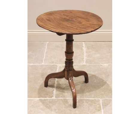 A 19th century mahogany tilt top tripod table, the circular top upon a ring turned tapering column and three down-sept suppor