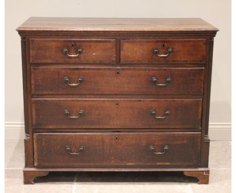 A George III oak and mahogany crossbanded chest of drawers, the rectangular three plank top above an arrangement of two short