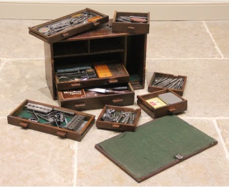 A late 19th/early 20th century stained pine joiners tool chest, the removable front panel enclosing an arrangement of small d
