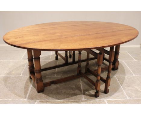A 17th century style oak wake table, late 20th century, on substantial ring turned legs and block feet, united by peripheral 
