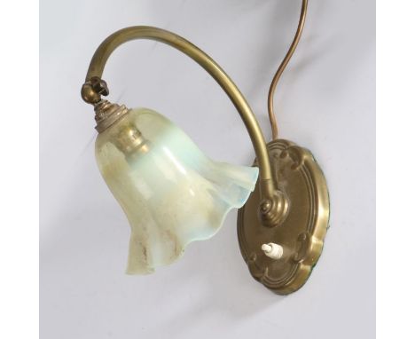 Brass desk lamp, with frilled opaline glass shade above an adjustable curved arm and scroll decorated oval base, 25cm high