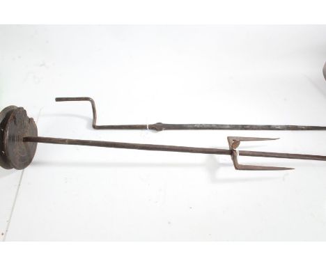 Iron roasting spit rods, with wooden pulley and adjustable fork to one section, the opposing side with handle