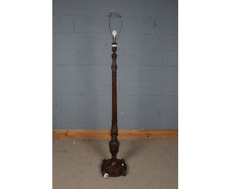 20th century carved oak standard lamp, carved with garlands and leaves, with fluted column and circular base