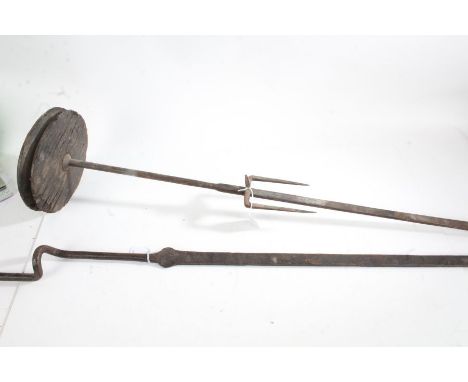 Iron roasting spit rods, with wooden pulley and adjustable fork to one section, the opposing side with handle