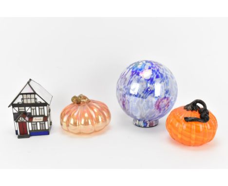 Two hand blown glass pumpkins by Ken and Ingrid Hanson, one in iridescent light orange, the other with black and aventurine s