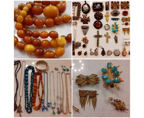 Victorian and later costume jewellery, mainly brooches and pendants to include a Scottish white metal and amber cabochon broo