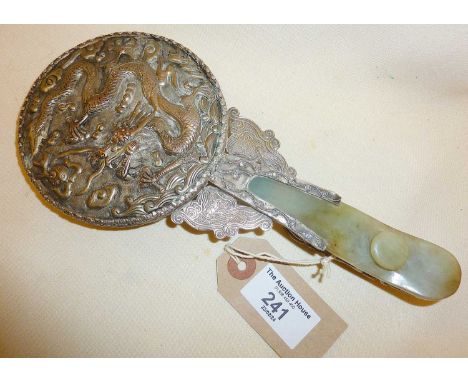Chinese silver and jade carved mirror, decorated with dragons, and with belt hook to handle, approx. 23cm long