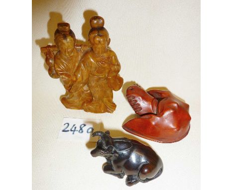 Japanese signed netsuke of an ox or bull, reconstituted amber figural group, and a carved wooden horseshoe crab