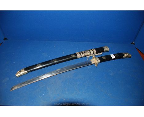 A Samurai style sword having a 19" long approx. blade marked "Kasu", the grip and scabbard terminating with fearsome beast ma