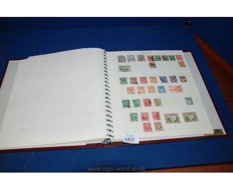 A Burgundy Stamp Album containing many worldwide Stamps including Borneo, Leeward Islands, Basutoland etc.