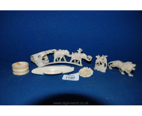 A small quantity of carved ivory/bone items including lion, brooch, nail buffer, etc.