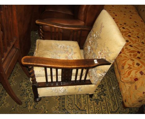 A circa 1910 Oak framed Armchair, long flat Oak arms on slatted supports and barley twist columns, square legs and bun feet. 
