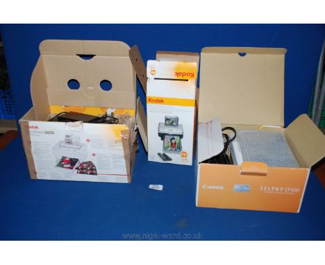 A Kodak Easy Share G600 Printer Dock together with a Canon Selphy CP400 Printer