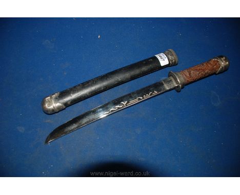 An oriental style sword with carved grip and having an 11 7/8" long polished blade and with sheath/scabbard.   