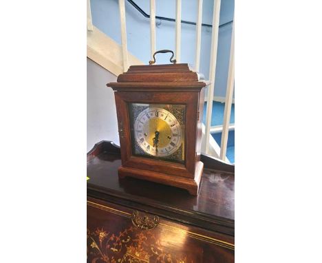 An oak cased mantle clock