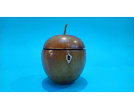 A reproduction apple shaped tea caddy