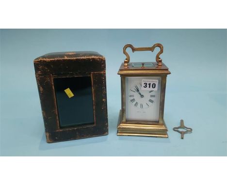 A brass carriage clock and fitted travelling case, the dial signed Lister and Son's