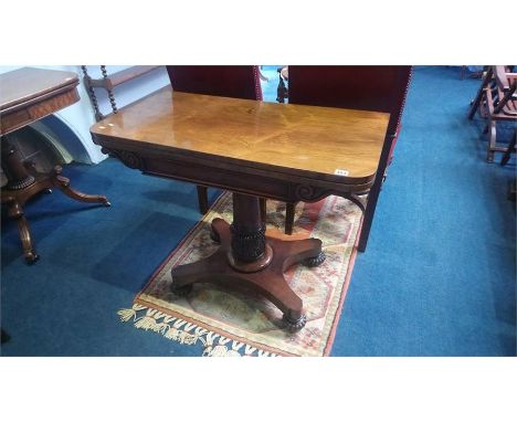 A William IV rosewood fold over card table, with turned and acanthus carved central column, supported on a quadruple platform