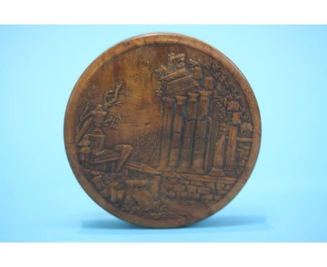 A walnut snuff box, decorated with a carved Classical scene